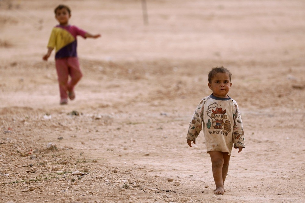 Displaced Syrian children from Deir Ezzor walk near a camp for displaced people in the province of Hasakeh, Oct. 8. 