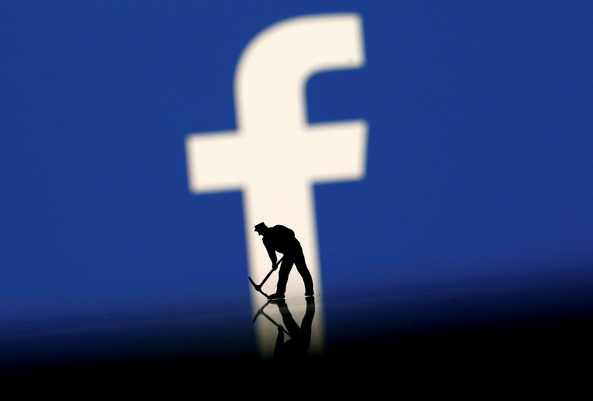 A figurine is seen in front of the Facebook logo in this illustration taken, March 20, 2018. (Reuters photo)