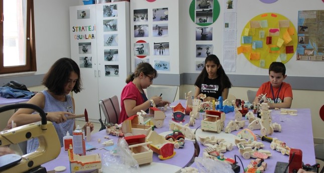 From cradles to cars, children build and paint wooden toys at the workshop.