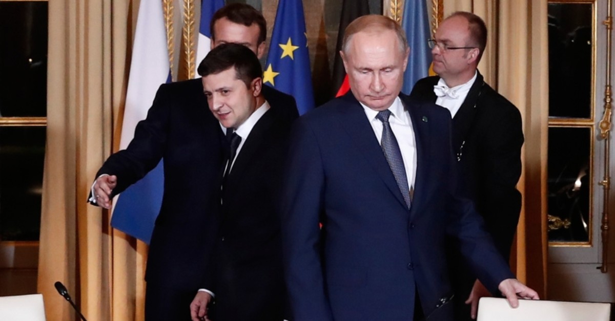Russian President Vladimir Putin, right, and Ukrainian President Volodymyr Zelenskiy arrive for a working session at the Elysee Palace Monday, Dec. 9, 2019 in Paris. (AP Photo)