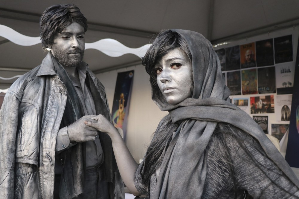 Living statue performers perform with intense concentration, standing still for hours.