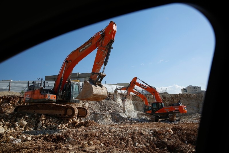 In this Tuesday, Jan. 1, 2019 photo, men work on a new housing project in the West Bank settlement of Modin ilit. (AP Photo)