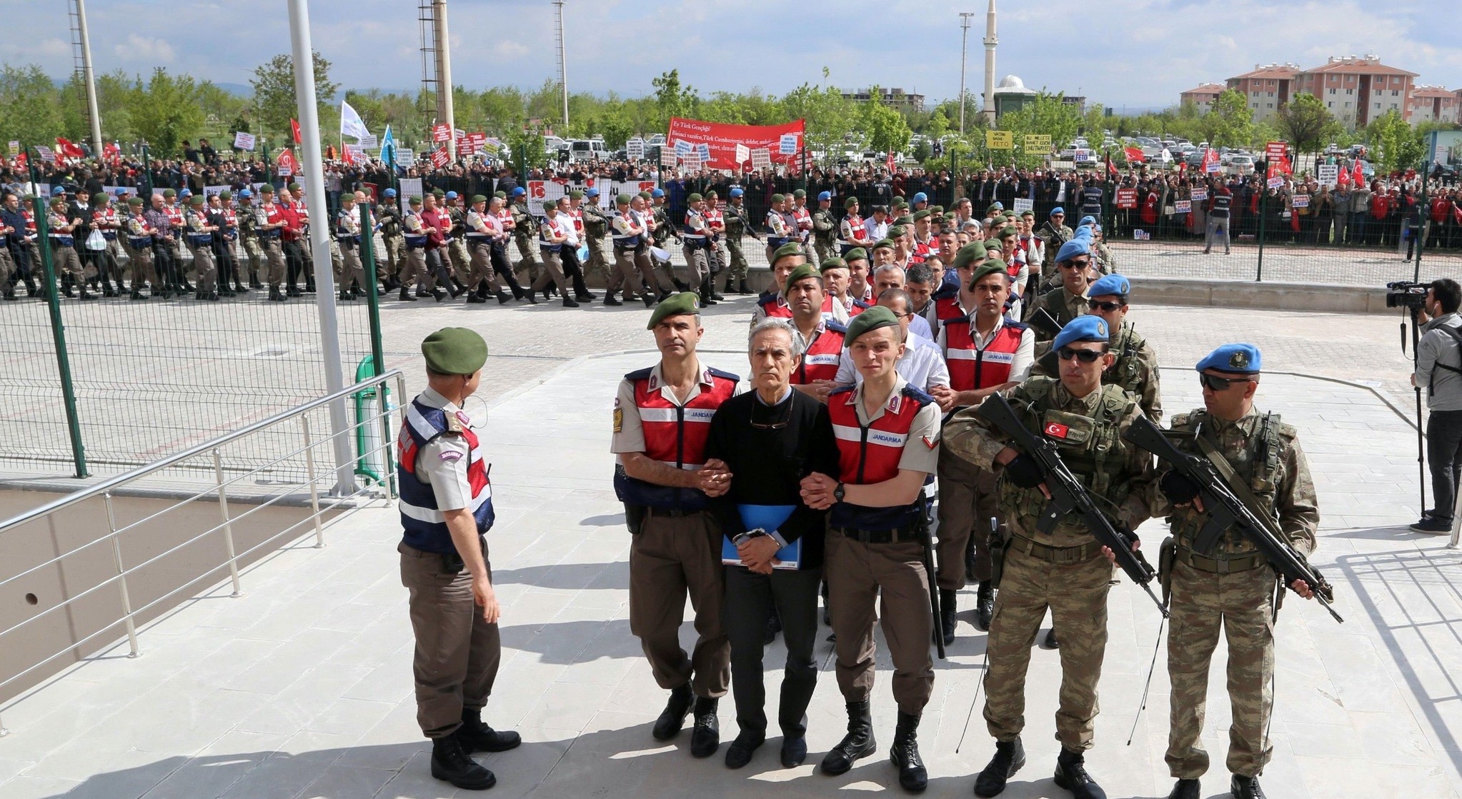 Turkish Gendarmerie escort defendants Akin u00d6ztu00fcrk (3L) and others involved in July 15, 2016u2019s attempted coup as they leave the prison where they are being held, ahead of their trial in Ankara in 2017.