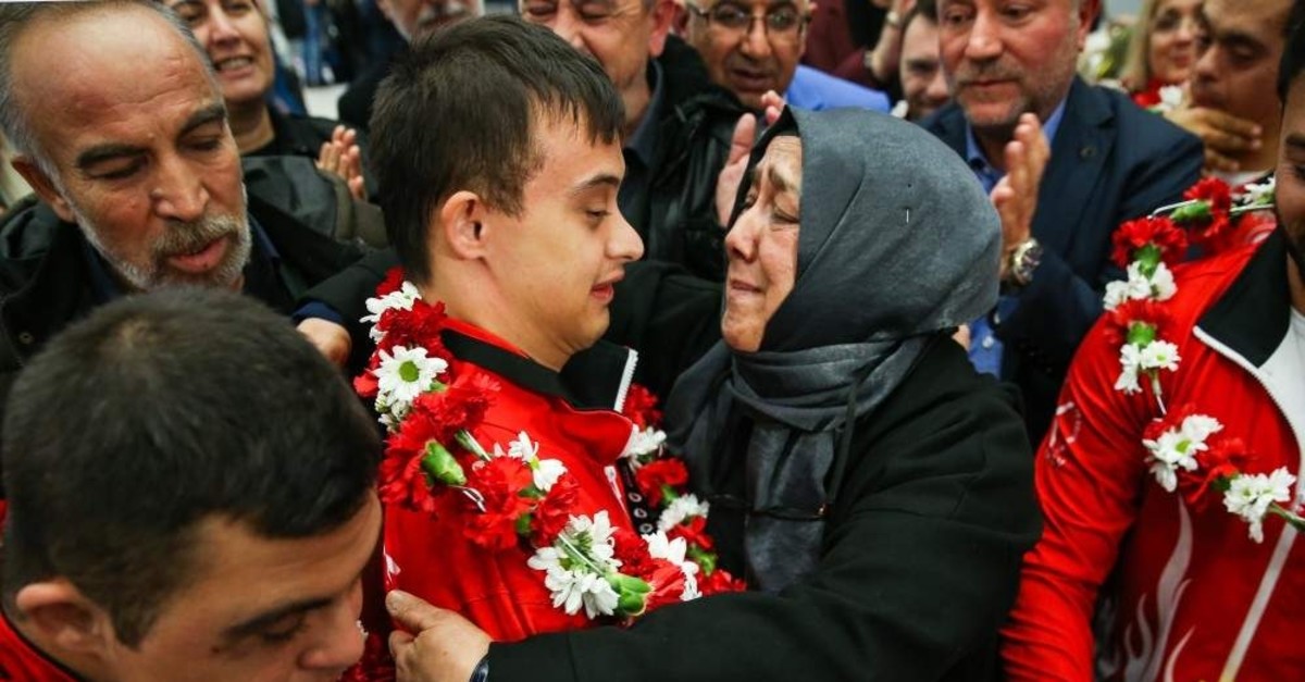 Semiha Erdem hugs her son Talha Ahmet Erdem at the airport as he returns from Portugal after winning gold, Dec. 2, 2019. (AA Photo)