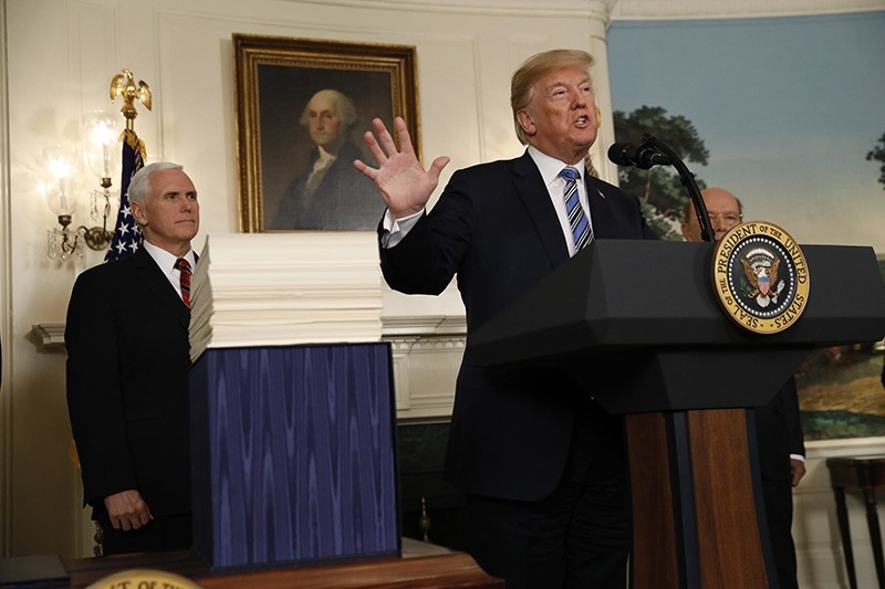 U.S. President Donald Trump speaks with Vice President Mike Pence at his side as holds an event to sign Congress' $1.3 trillion spending bill (Reuters Photo)