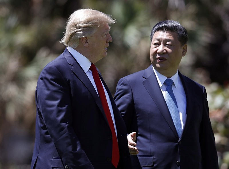 - In this April 7, 2017 file photo, President Donald Trump, left, and Chinese President Xi Jinping walk together after their meetings at Mar-a-Lago, in Palm Beach, Fla. (AP Photo)