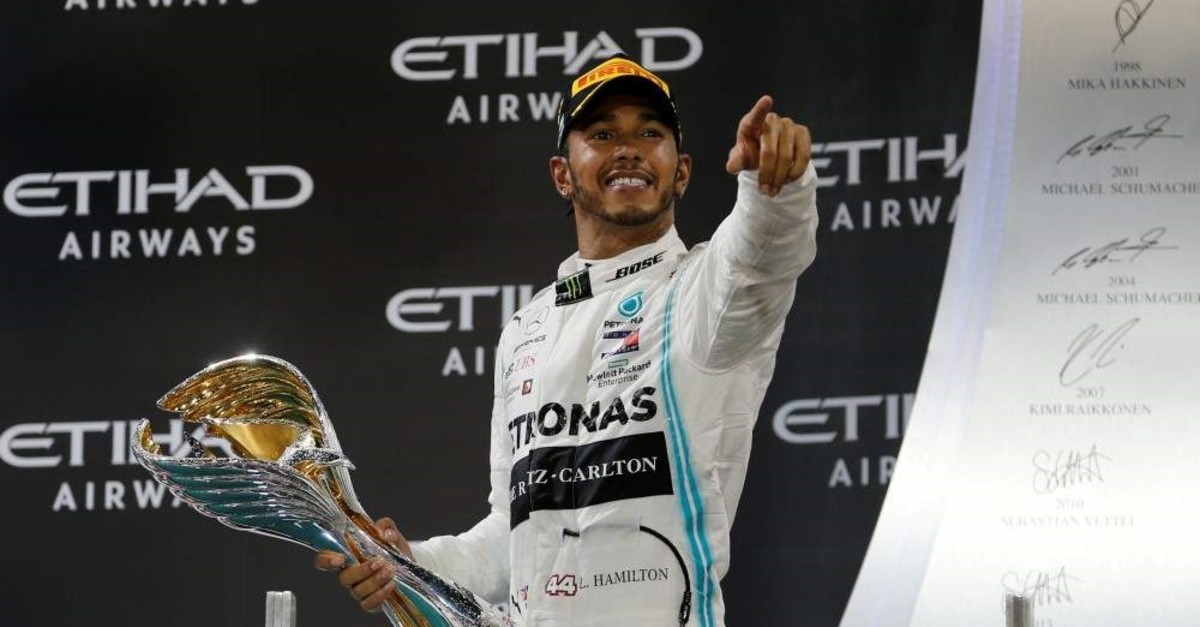 Lewis Hamilton celebrates with a trophy after winning the race, Abu Dhabi, Dec. 1, 2019. (REUTERS Photo)