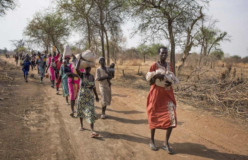 Thousands of people walk for hours to reach a food distribution site in Malualkuel, in the Northern Bahr el Ghazal region of South Sudan. AP Photo 