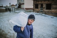 A member of the Dukha community carries an aid package donated by Tu0130KA in Tsaganur, Mongolia, March 2019.