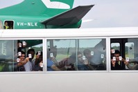 In this Aug. 2, 2013, photo, a group of asylum seekers hold up their identity after landing in Manus Island, Papua New Guinea. (AP Photo)