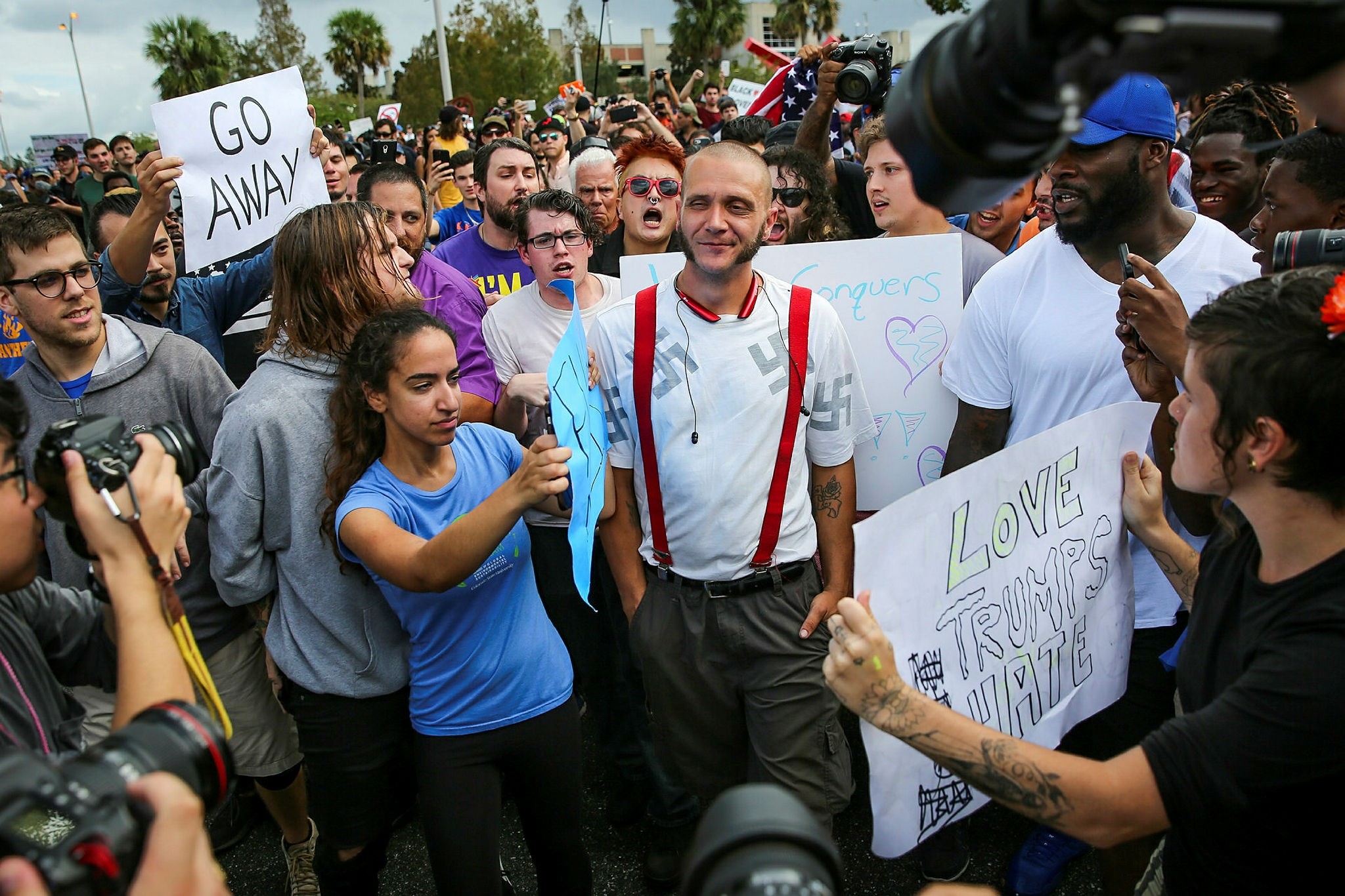 Protesters confront a man wearing a shirt with swastikas outside a University of Florida auditorium where white nationalist Richard Spencer was preparing to speak, Oct. 19.