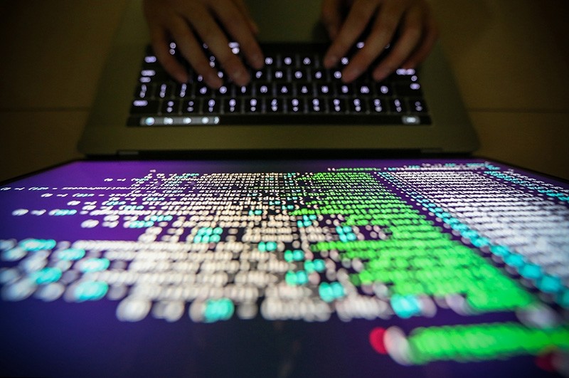 A programer shows a sample of decrypting source code in Taipei, Taiwan. (EPA Photo)