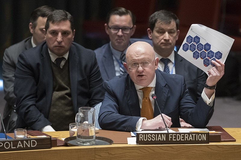 Russian Ambassador to the United Nations Vassily Nebenzia holds up a British report on the Salisbury Incident as he speaks during a Security Council meeting on the situation between Britain and Russia on April 5, 2018 at UN headquarters. (AP Photo)