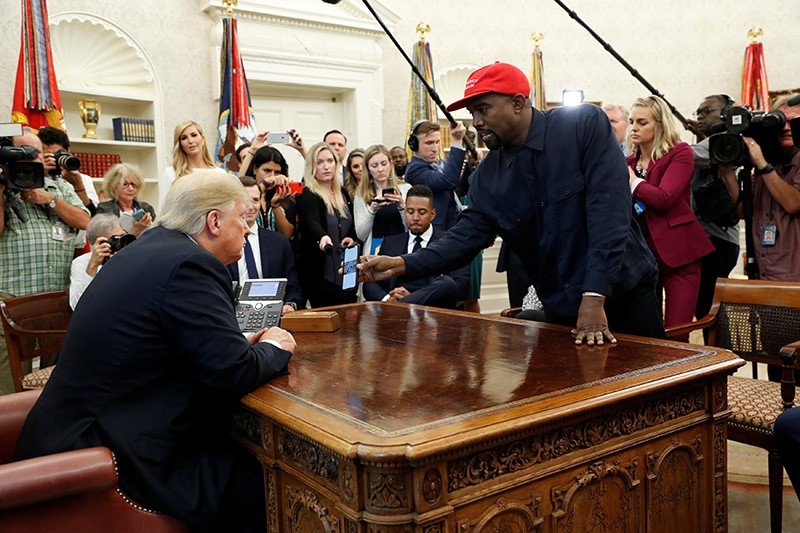 Rapper Kanye West shows President Donald Trump his mobile phone during a meeting in the Oval Office at the White House in Washington, U.S., Oct. 11, 2018. (Reuters Photo)