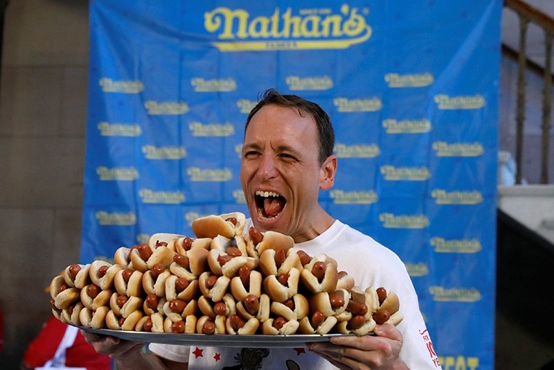 world record holder Joey Chestnut poses with a plate of hot dogs during the official weigh-in ceremony for the Nathan's Famous Fourth of July International Hot Dog Eating Contest in Brooklyn, New York City (Reuters Photo)