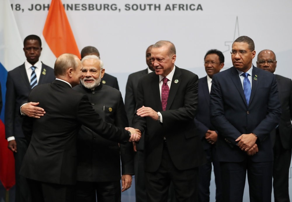 President Recep Tayyip Erdou011fan shakes hands with Russian President Vladimir Putin (L) next to Indian Prime Minister Narendra Modin (C) before taking a group picture at the BRICS summit meeting, Johannesburg, July 27.