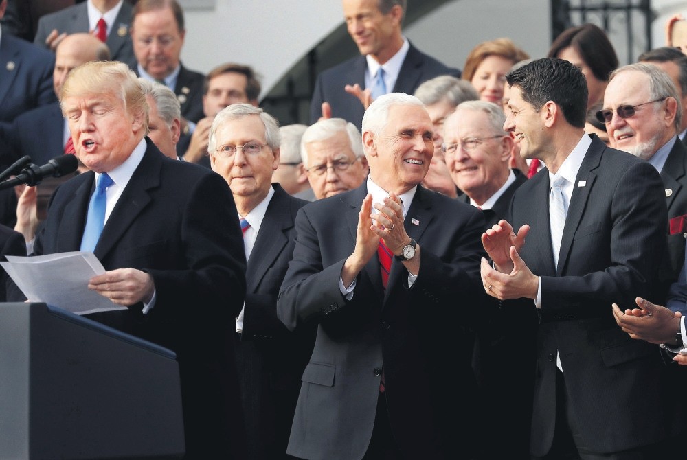 U.S. President Trump (L) celebrates with congressional Republicans after U.S. Congress passed sweeping tax overhaul legislation, Washington, Dec. 20 2017.