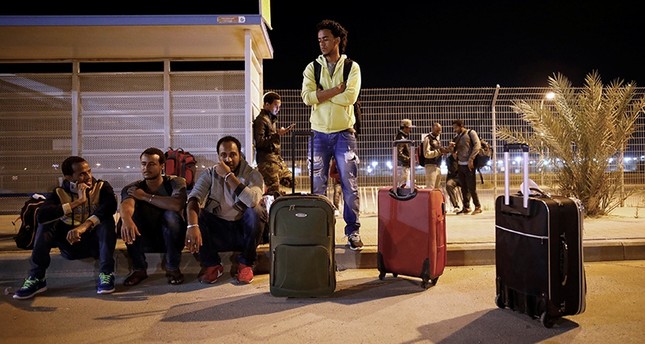 African migrants wait for a bus after being released from Saharonim Prison in the Negev desert, Israel April 4, 2018. (Reuters Photo)