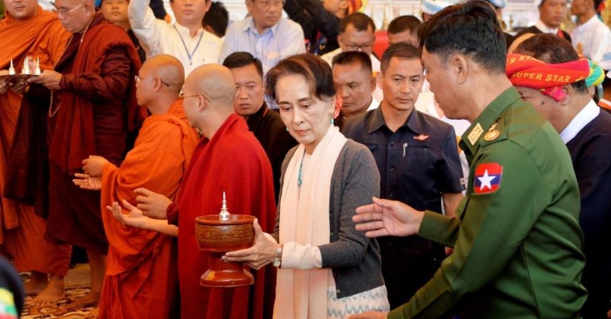Myanmar's State Counselor Aung San Suu Kyi (C) and Home Affairs Minister Lt. Gen. Kyaw Swe (R) attending the opening ceremony of a new pagoda at Kyauktalonegyi city, Shan State, Nov. 20, 2019. (AFP Photo)