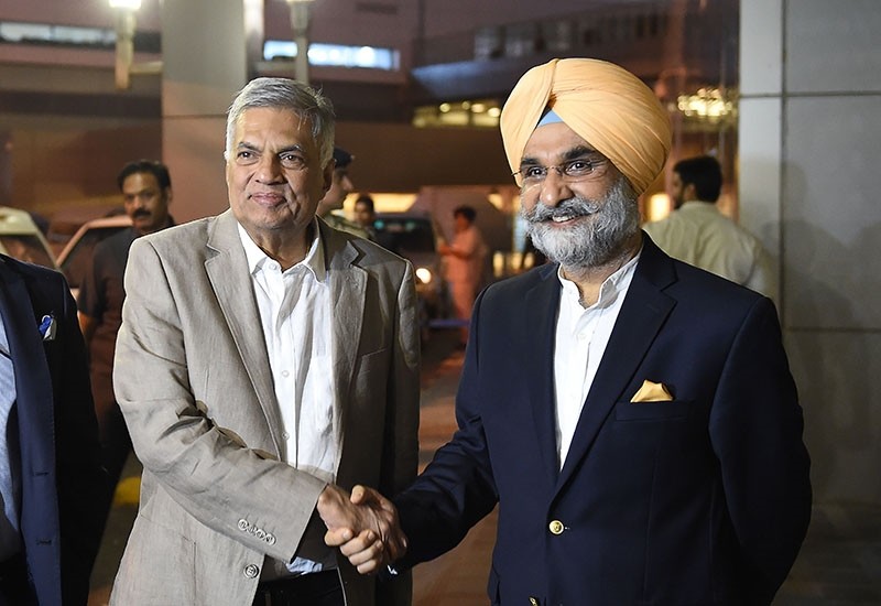 Sri Lanka's Prime Minister Ranil Wickremesinghe (L) shakes hands with Taranjit Singh Sandhu, High Commissioner of India to Sri Lanka during his arrival at the Indira Gandhi International Airport on Oct. 18, 2018. (AFP Photo)