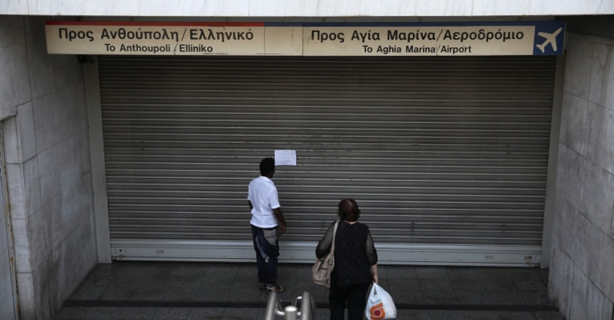 People read an announcement at a closed metro station, during a 24-hour general strike in Athens, Greece, Oct. 2, 2019. (Reuters Photo)