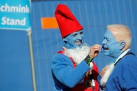 A participant dressed as a smurf paints a man's face blue before an attempt to hold the world's largest meeting of smurfs (Reuters Photo)