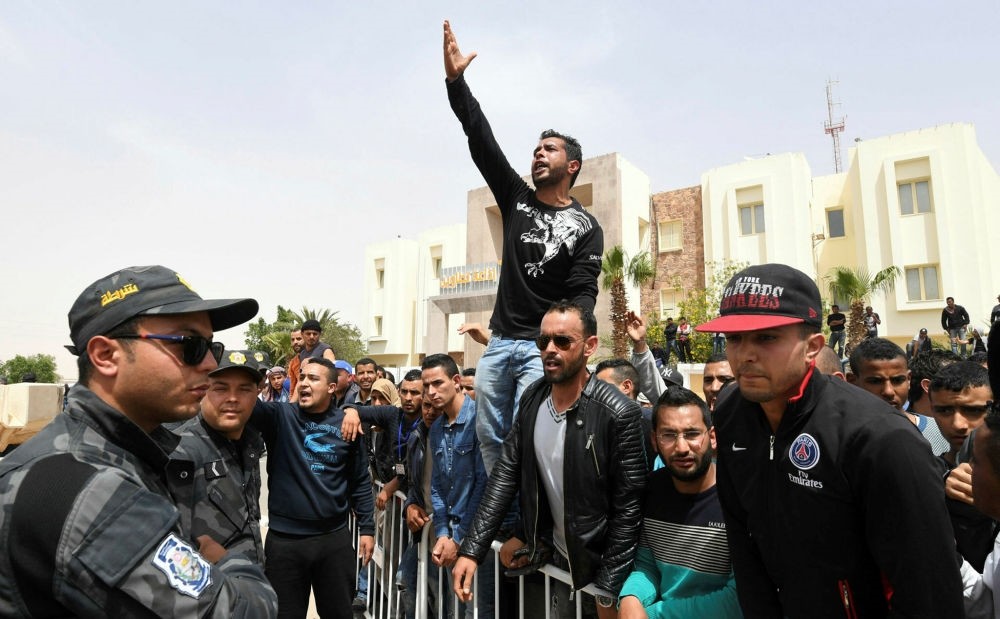 Tunisian protestors shout slogans during a visit by their prime minister in the town of Tataouine on April 27.