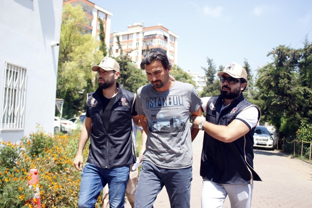Anti-terrorism police escort Karacan following his capture.