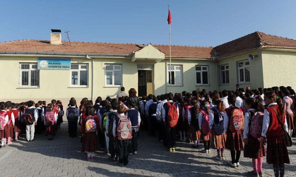 Students gather for the daily routine of reciting the student oath in front of their school, in 2012.