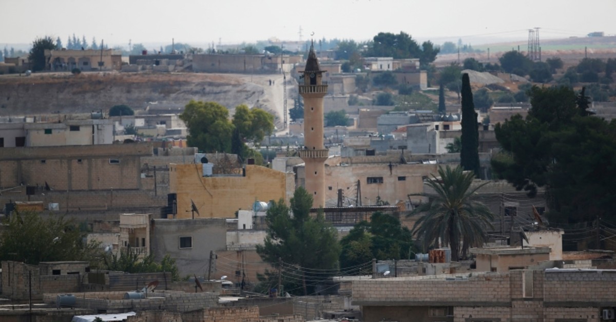In this photo taken from the Turkish side of the border between Turkey and Syria, in Aku00e7akale, u015eanlu0131urfa province, southeastern Turkey, a view of the town of Tal Abyad, Syria, Tuesday, Oct. 22, 2019. (AP Photo)
