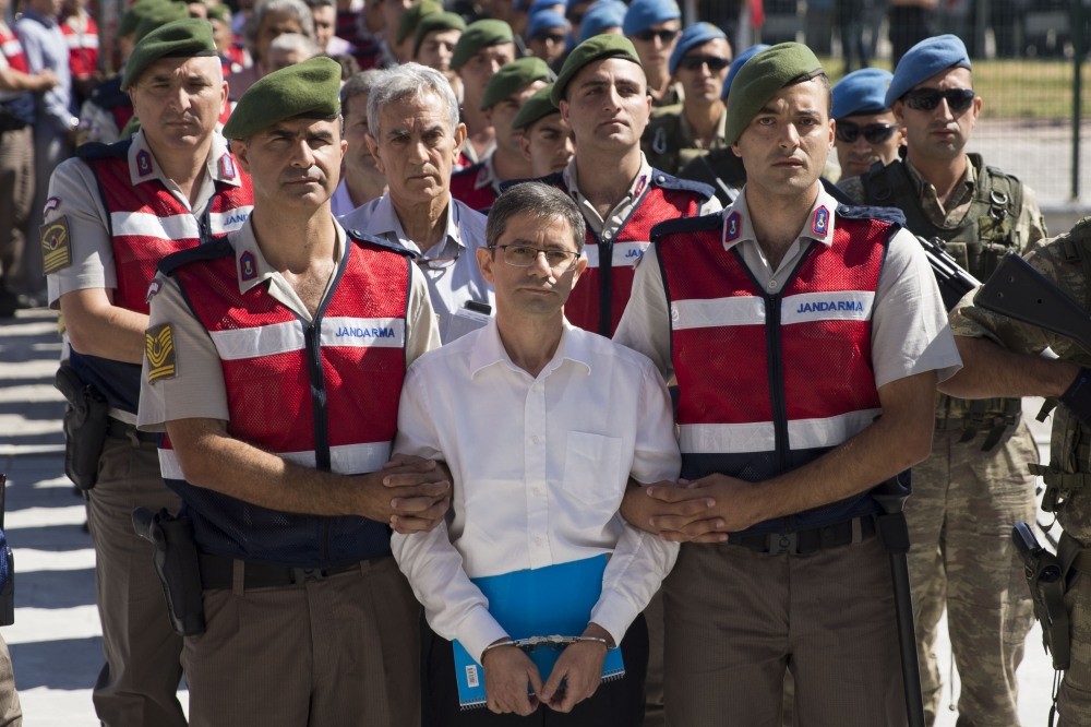 Former general Aku0131n u00d6ztu00fcrk follows Kemal Batmaz as they are escorted to the court. Batmaz, executive of FETu00d6-linked company Kaynak Kau011fu0131t, commanded u00d6ztu00fcrk and others in groupu2019s coup plot before both men were captured in the same military base.