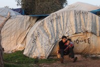 A Syrian teenager hugs his brother in front of their tent in the Atme Refugee Camp. A few days ago, a rocket fired by YPG terrorists hit the camp where Syrian refugees took refugee after fleeing terrorist attacks by in their hometowns. 