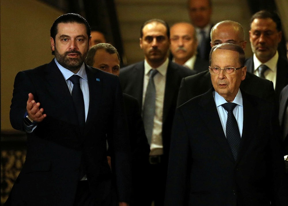 Former Lebanese Prime Minister Saad Hariri, left, welcomes Christian leader Michel Aoun, right, after he announced his support for Aoun to be the Lebanese president, in Beirut, Lebanon.(AP Photo)
