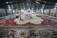 Restoration crew works on the 120-year-old carpet in a warehouse set up in the courtyard of Yu0131ldu0131z Chalet.