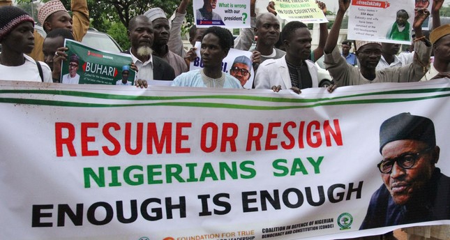 Protesters carry placards to demand that ailing President Buhari resume work or resign in Abuja, on August 7, 2017. (AFP Photo)