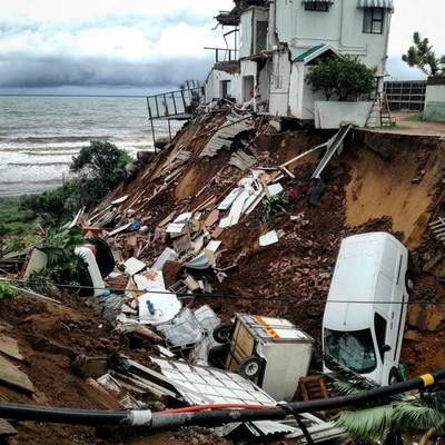 Vehicles and debris scattered on side of a cliff in Durban. (Reuters)