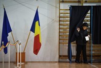A woman exits a voting booth during the second round of presidential elections in Bucharest November 24, 2019. (AFP Photo)