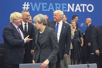 U.S. President Donald Trump jokes with British Foreign Minister Boris Johnson as British Prime Minister Theresa May walks past during a meeting at NATO headquarters during a NATO summit of heads of state and government in Brussels, May 25, 2017.