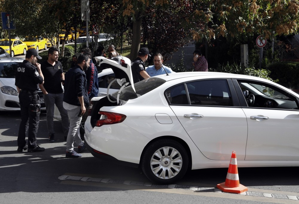The police search a car near the Iranian embassy in Ankara, Turkey after unconfirmed reports of a suicide bomb threat to the diplomatic mission.