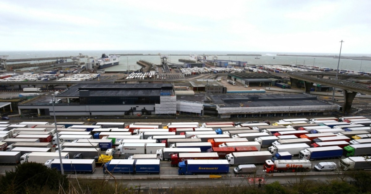 Lorries queue at the entrance to the Port of Dover ferry terminal in southern England, as bad weather causes heavy seas and delays to the cross Channel ferry, Tuesday, March 12, 2019. (PA via AP)
