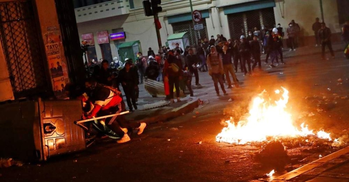Demonstrators hide behind makeshift barriers during a protest in La Paz, Bolivia, Oct. 31, 2019. (REUTERS)