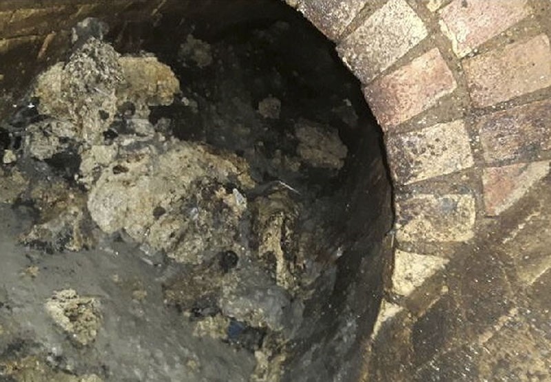 In this undated handout photo issued by Thames Water on Tuesday, Sept. 12, 2017, a view of part of a fatberg inside a sewer in Whitechapel, London. (Thames Water via AP)