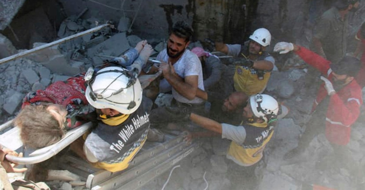 This photo shows Syrian White Helmet civil defense workers carry an injured girl on a stretcher after an airstrike hit the northern town of Ariha, in Idlib province, Syria, Saturday, July 27, 2019. (AP Photo)