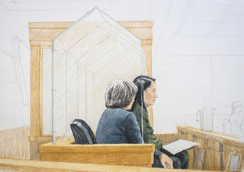In this courtroom sketch, Meng Wanzhou, right, the chief financial officer of Huawei Technologies, sits beside a translator during a bail hearing at British Columbia Supreme Court in Vancouver, on Friday, Dec.  7, 2018. (The Canadian Press via AP)