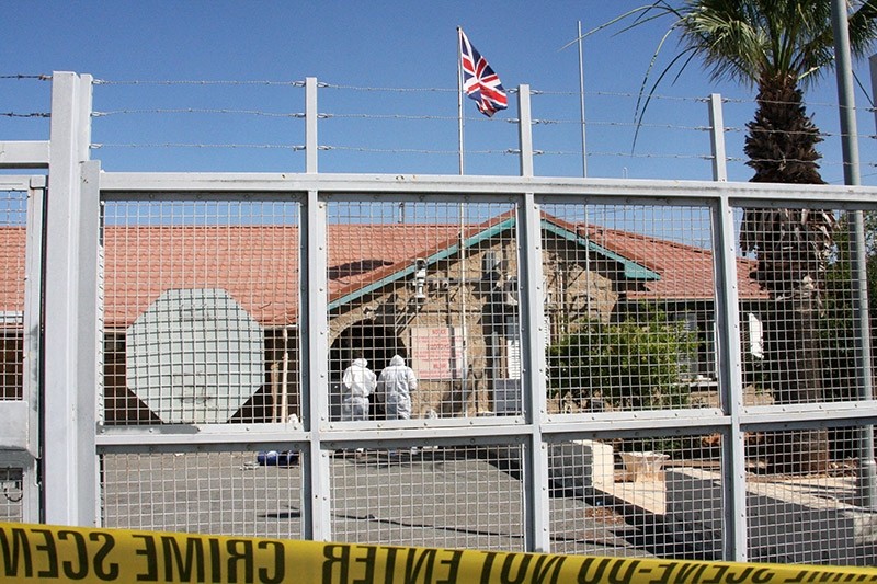Forensic officers inspect the scene of a small explosion outside a police station in the British Sovereign Base Area (SBA) of Dhekelia, Cyprus, 13 June 2017 (EPA Photo)