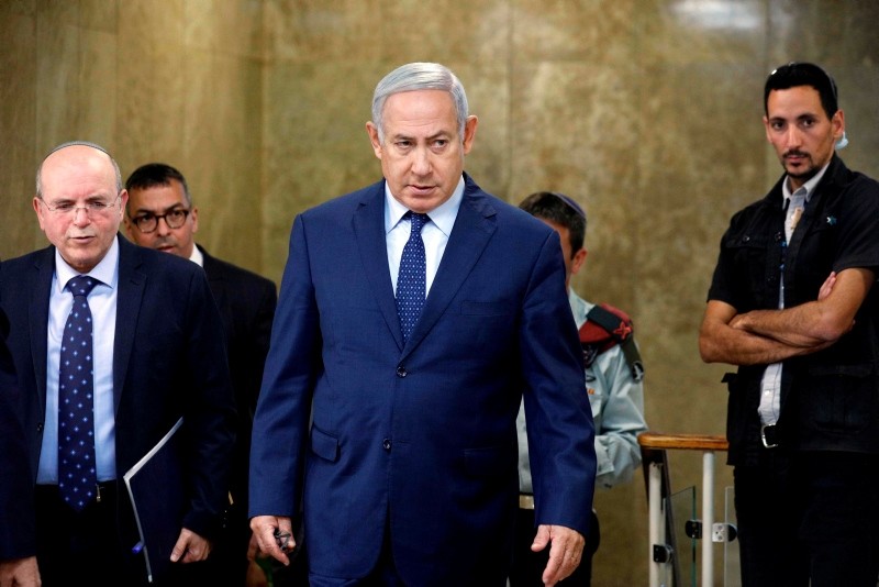 Israeli Prime Minister Benjamin Netanyahu (C) arrives for the weekly cabinet meeting at the Prime Minister's office in Jerusalem on October 14, 2018.  (AFP Photo)