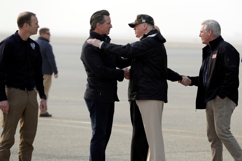 President Donald Trump greets California Gov.-elect Gavin Newsom as he arrives on Air Force One at Beale Air Force Base for a visit to areas impacted by the wildfires, Saturday, Nov. 17, 2018. (AP Photo)