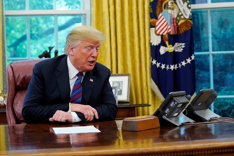 U.S. President Donald Trump speaks to Mexican President Enrique Pena Nieto on the phone as he makes an announcement on status of NAFTA from the Oval Office of the White House in Washington, U.S., Aug. 27, 2018. (Reuters Photo)