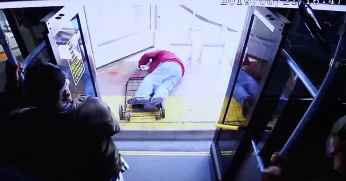 A man falls on the ground after being pushed out of a bus in downtown Las Vegas, Nevada, U.S. March 21, 2019, in this still image taken from video obtained from social media. (Las Vegas Metropolitan Police/via REUTERS)
