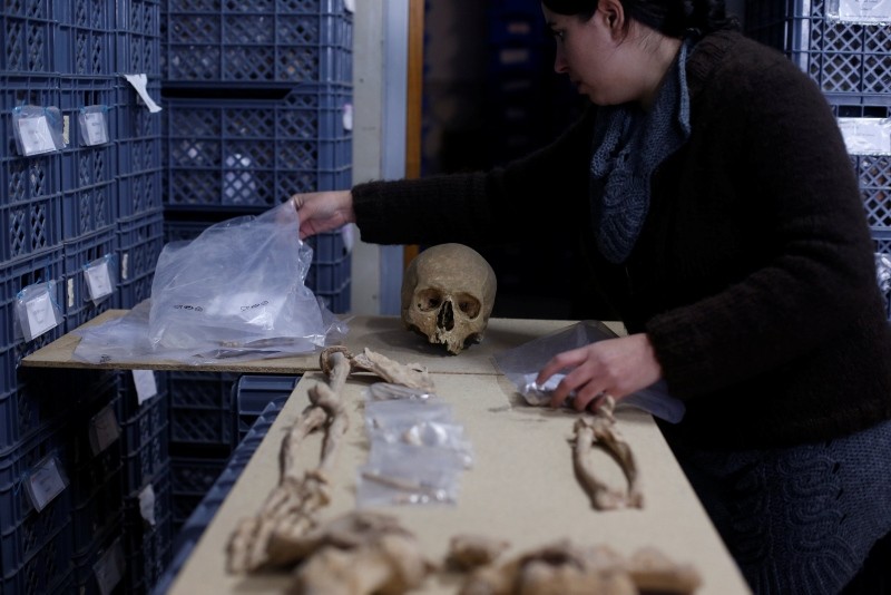 A person works on a skeleton from an ancient Roman cemetery with 2000-year-old skeletons and various artefacts, found below a restaurant in Lisbon, Portugal (Reuters Photo)